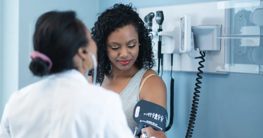 A person getting their blood pressure checked at the doctor's office. A person getting their blood pressure checked at the doctor's office.