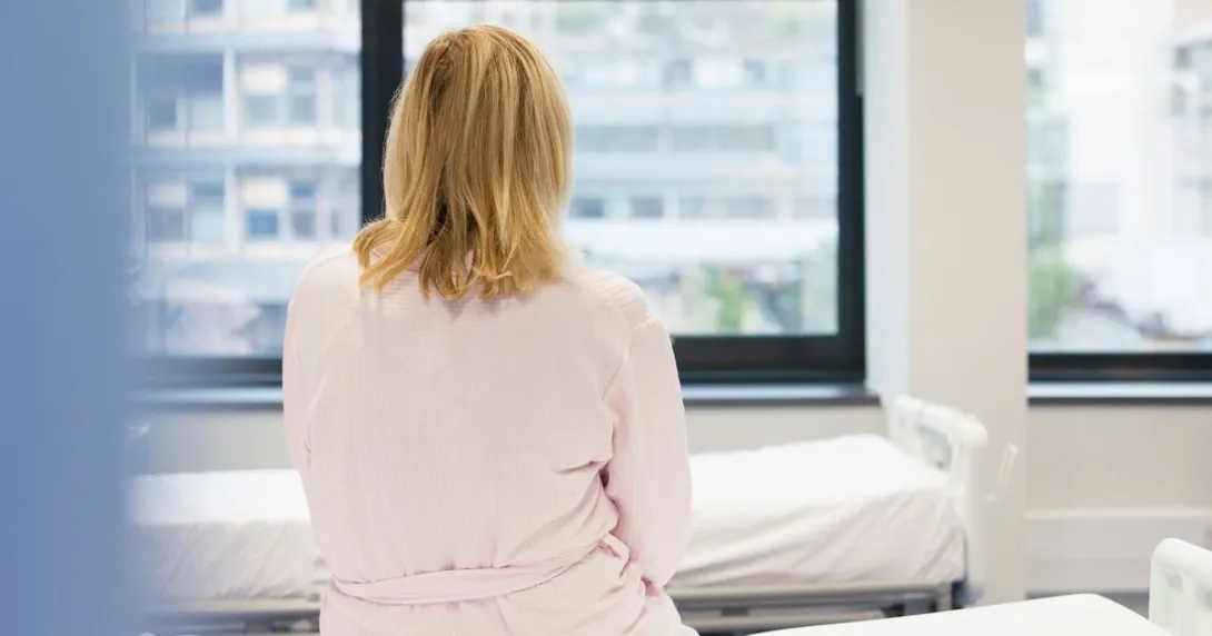 A photo of a woman sitting on a hospital bed A photo of a woman sitting on a hospital bed