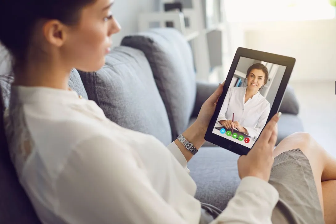 A woman talking to a provider on a tablet A woman talking to a provider on a tablet