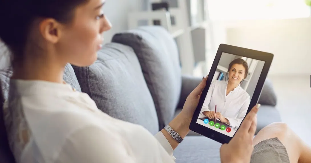 A woman talking to a provider using her tablet. A woman talking to a provider using her tablet.